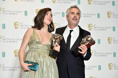 epa07360670 Mexican director Alfonso Cuaron (R) and his daughter Tessa pose with the awards for Best Film and Best Director for 'Roma' in the press room during the 72nd annual British Academy Film Awards at the Royal Albert Hall in London, Britain, 10 February 2019. The ceremony is hosted by the British Academy of Film and Television Arts (BAFTA).  EPA/NIK HALLEN