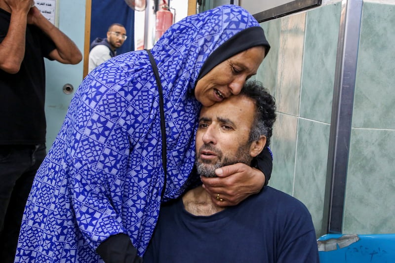 A newly released Palestinian who was detained by the Israeli army is hugged by a relative at a hospital in Rafah. Reuters