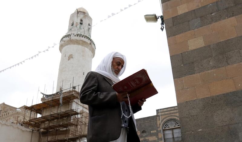 A Yemeni man reads the Quran at a mosque in Sanaa. EPA