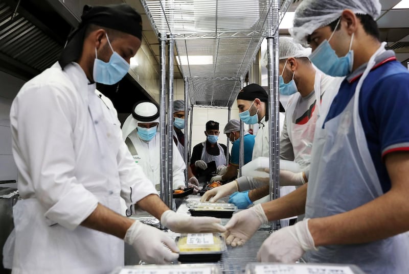 DUBAI, UNITED ARAB EMIRATES , May 01 – 2020 :- Staff of Al Nadeg restaurant in Deira Dubai preparing the food packets to deliver at the labour camp in Al Muhaisnah area in Dubai. This is a part of Mohammed Bin Rashid Al Maktoum 10 Million Meals Global Initiative. Volunteers from Beit Al Khair Society will distribute the food packets in the labour camps. Today they are delivering 1000 food packets from Al Nadeg restaurant. Total 12000 food packets will be deliver in different labour camps in Dubai. (Pawan Singh / The National) For News/Online/Instagram. Story by Anam