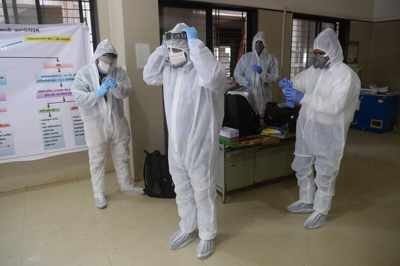 Medical staff don PPE during a coronavirus screening at the Covid-19 facility of the civil hospital in Nashik, India.  AFP