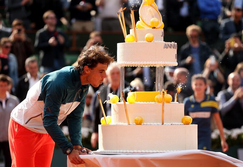 PARIS, FRANCE - JUNE 03:  Rafael Nadal of Spain  blows out the candles on a giant birthday cake after victory in his Men's Singles match against Kei Nishikori of Japan during day nine of the French Open at Roland Garros on June 3, 2013 in Paris, France.  (Photo by Matthew Stockman/Getty Images) *** Local Caption ***  169856067.jpg