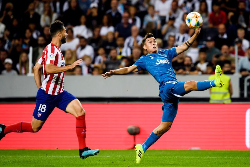 Juventus Paulo Dybala, right, stretches for the ball. AP Photo