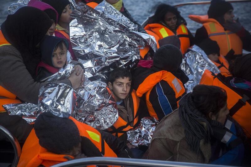 Refugees arrive on a vessel of Frontex, European Border Protection Agency, after their rescue near the Greek island of Lesbos. Santi Palacios / AP Photo