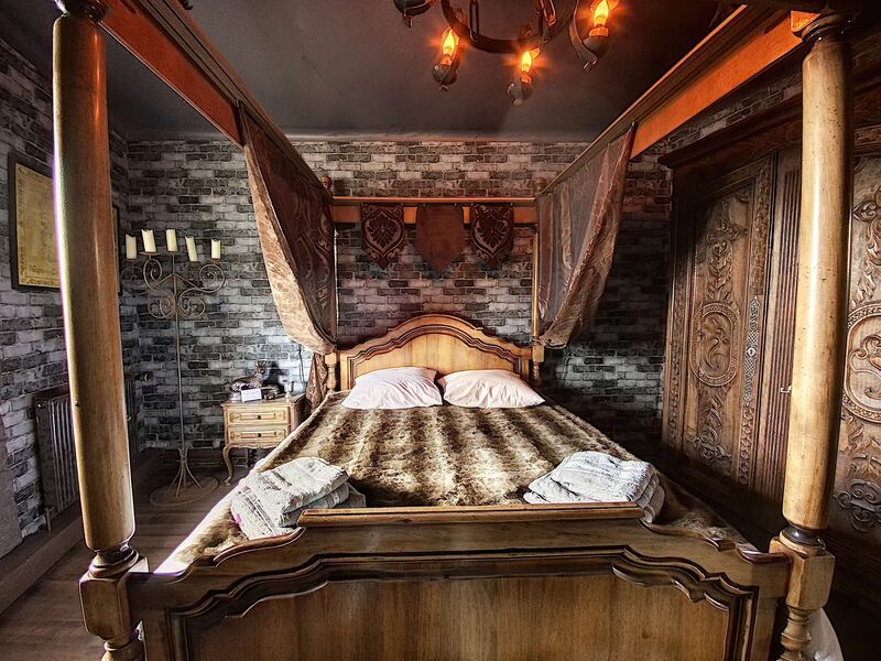 The property features a life-sized Iron Throne, medieval weaponry and a statuesque four-poster bed. Photo: Morgan Rebouche
