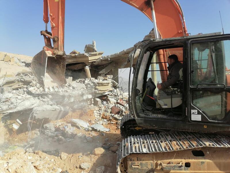 An excavator removes debris left after an air strike at headquarters of Kataib Hezbollah militia group in Qaim, Iraq. Reuters