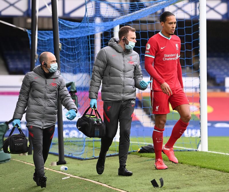 Virgil van Dijk limps off against Everton. EPA