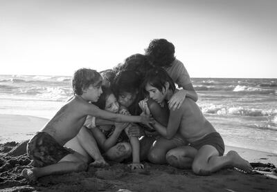 This image released by Netflix shows Yalitza Aparicio, center, in a scene from the film "Roma," by filmmaker Alfonso Cuaron. (Carlos Somonte/Netflix via AP)
