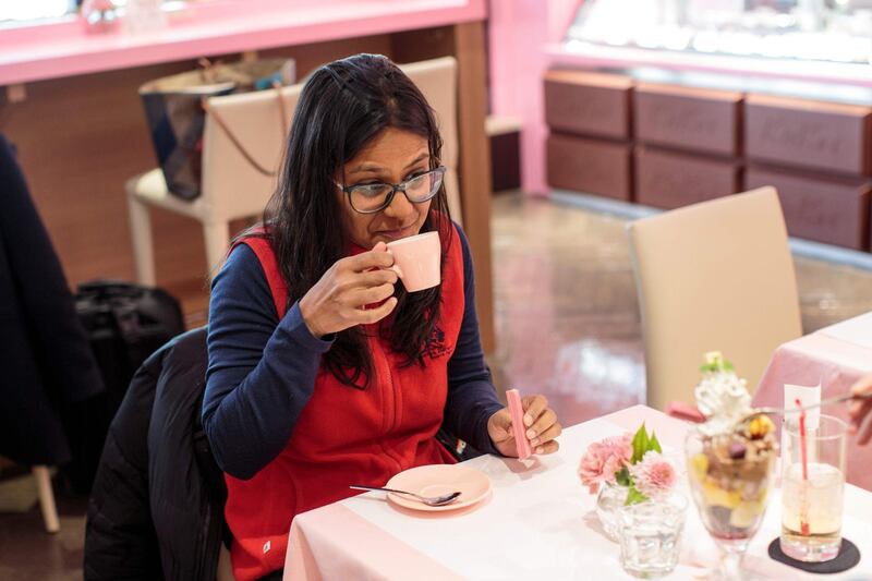 In this picture taken on February 7, 2018, a tourist from Australia, Ayndri de Soysa, tastes a ruby hot chocolate as she holds a ruby Kitkat bar at a KitKat chocolatory shop in Tokyo.
It is a marriage made in Heaven for cute-obsessed Japan: this Valentine's Day, lovers can present the object of their affection with a world first -- naturally bright pink chocolate. / AFP PHOTO / Behrouz MEHRI / TO GO WITH Japan-lifestyle-Valentine,FEATURE by Anne BEADE