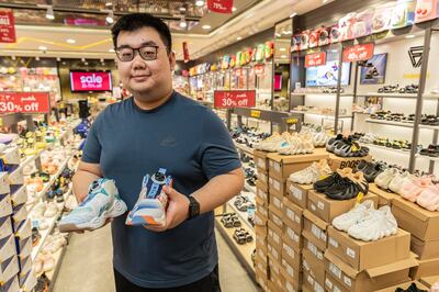 Bingbing Chen, pictured at Lucky Shoes in Deira City Centre mall, has returned to Dubai after studying in the US to grow his family footwear business. Antonie Robertson / The National


