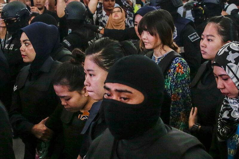epaselect epa06285246 Siti Aisyah (2-L) of Indonesia and Doan Thi Huong (2-R) of Vietnam - who are on trial for the assasination of Kim Jong-nam, the estranged half-brother of North Korea's leader Kim Jong-un - are escorted as they revisit scene of the attack at Kuala Lumpur International Airport 2 in Sepang, Malaysia, 24 October 2017.  Doan Thi Huong from Vietnam and Siti Aisyah from Indonesia, charged with murder under Section 302 of the penal code, which carries mandatory death sentence if found guilty, pleaded not guilty during the murder trial.  EPA/FAZRY ISMAIL