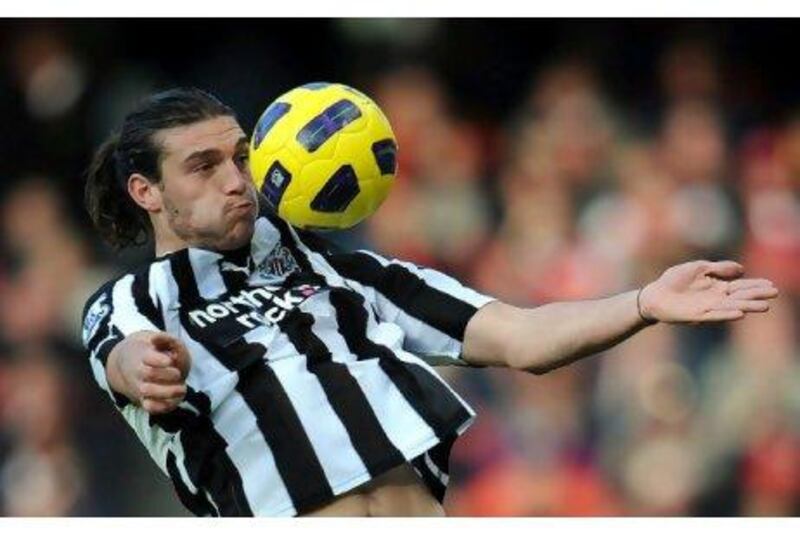 Andy Carroll, Newcastle United’s rugged centre-forward, controls the ball against Arsenal.