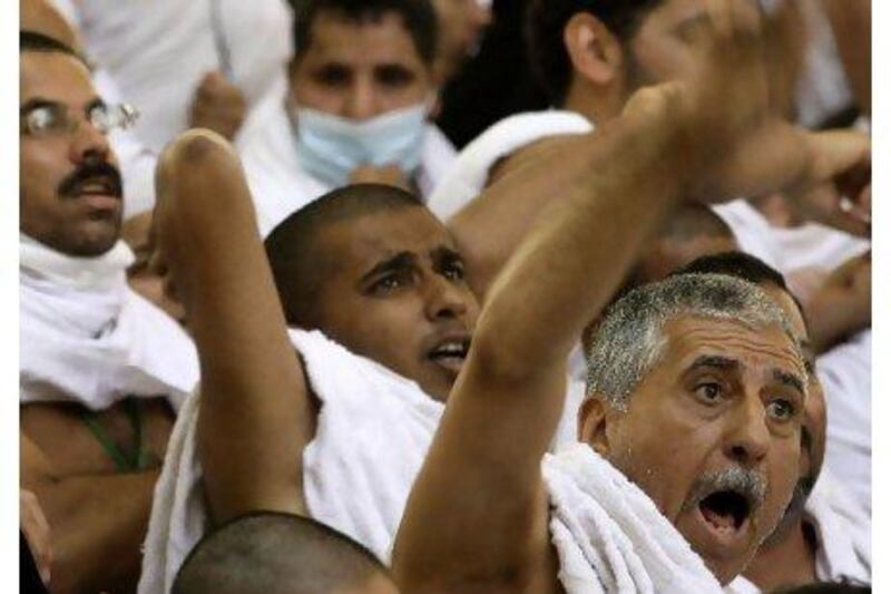 Muslim pilgrims cast stones at a pillar, symbolising the stoning of Satan, in a ritual called "Jamarat," the last rite of the annual hajj, in Mina near the Saudi holy city of Mecca.