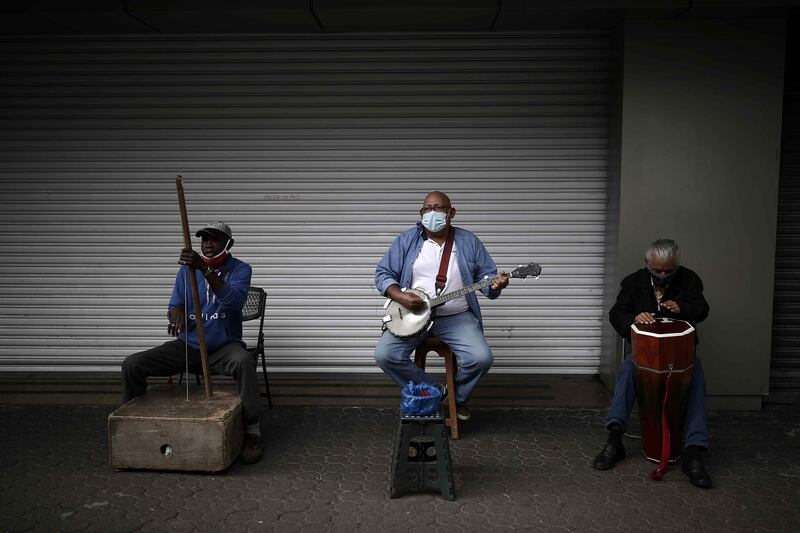 Men play instruments to entertain passersby on a street in San Jose, Costa Rica. EPA