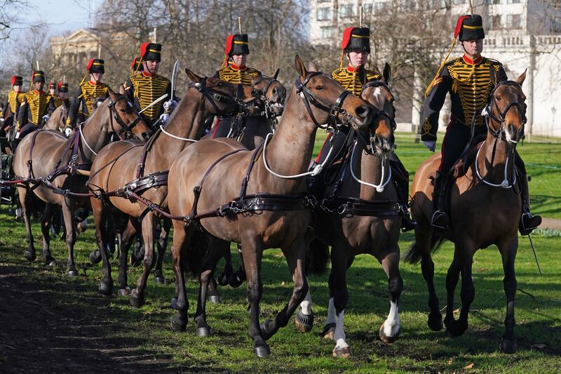 Members of the King's Troop, Royal Horse Artillery ride through Green Park. PA