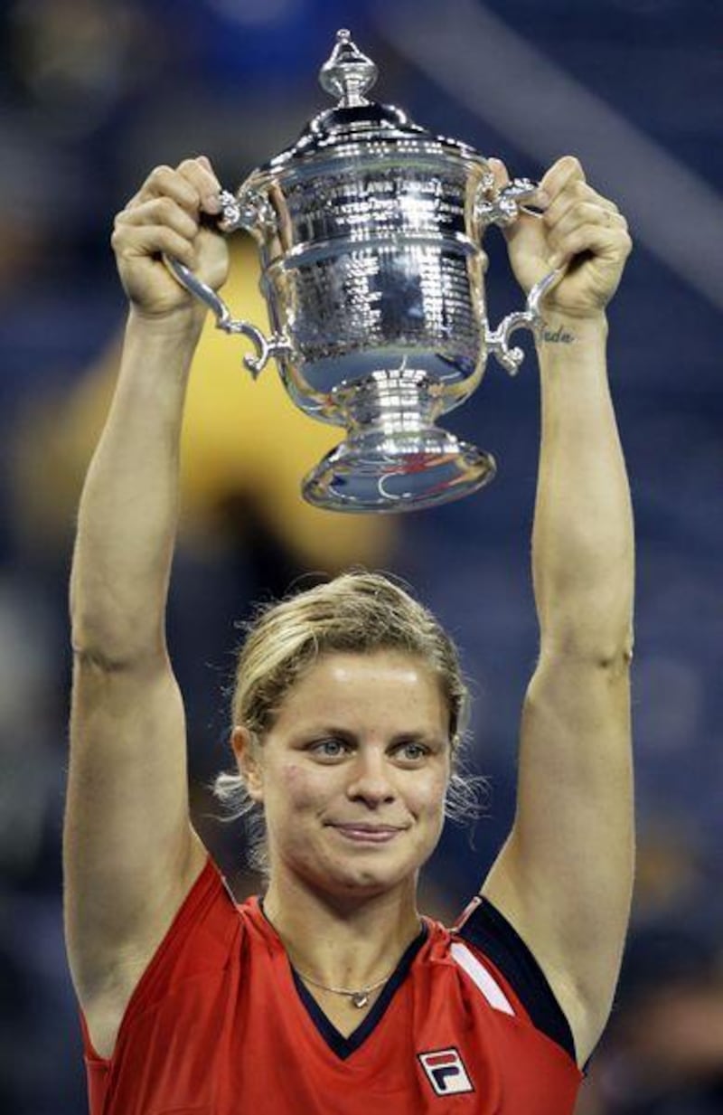 Kim Clijsters holds aloft the trophy after winning the women's singles title at the US Open.