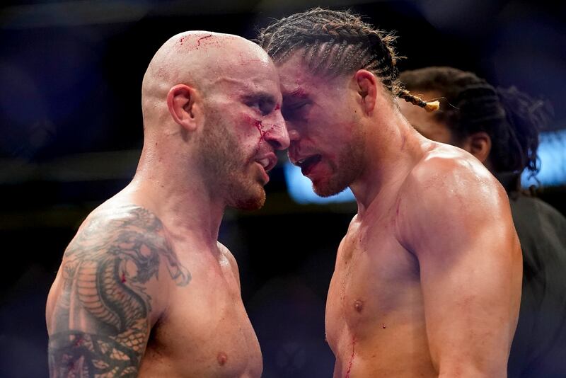 Alexander Volkanovski, left, and Brian Ortega talk at the end of their featherweight mixed martial arts title bout at UFC 266. AP Photo