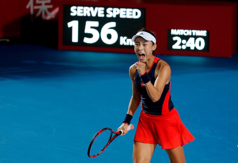 Wang Qiang of China celebrates winning her women's singles semi-final match against Garbine Muguruza of Spain at the Hong Kong Open tennis tournament on October 13, 2018. / AFP / Vivek PRAKASH
