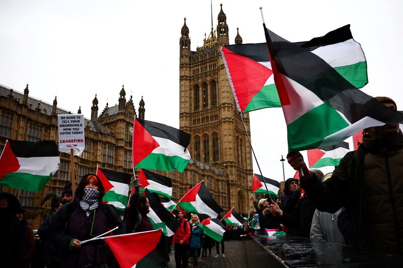 Demonstrators wave Palestinian flags in Parliament Square in London on February 21 as the House of Commons voted on a call for an immediate ceasefire in Gaza. AFP