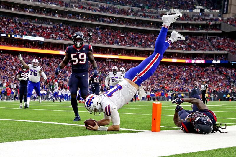 Buffalo Bills quarterback Josh Allen scores a touchdown against Houston Texans during the first quarter of their NFL wildcard game at NRG Stadium. The Texans won 22-19. USA TODAY Sports