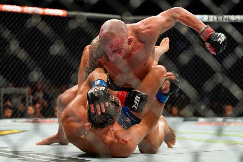 Alexander Volkanovski, top, punches Brian Ortega. AP Photo