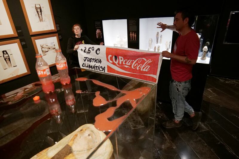 Climate protesters from Futuro Vegetal pose after throwing syrup and beetroot juice at the Egyptian Museum in Barcelona. Reuters