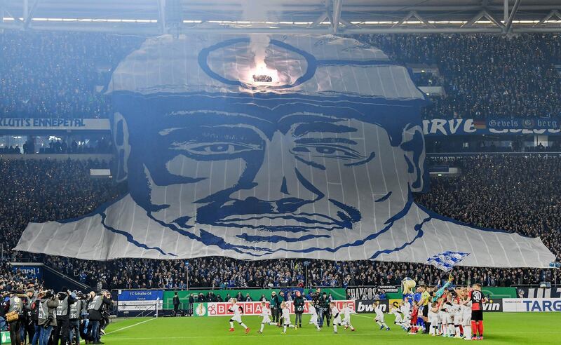 Schalke fans hold up a giant image of a coal miner ahead of the German Cup match against Hertha Berlin in Gelsenkirchen, on Tuesday, February 4. AP