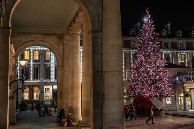 A Christmas tree is illuminated in Covent Garden. Getty Images