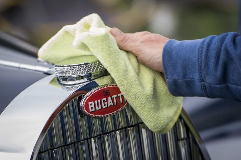 An exhibitor cleans a 1939 Bugatti Automobiles SAS Type 57C Gangloff Aravis. Bloomberg