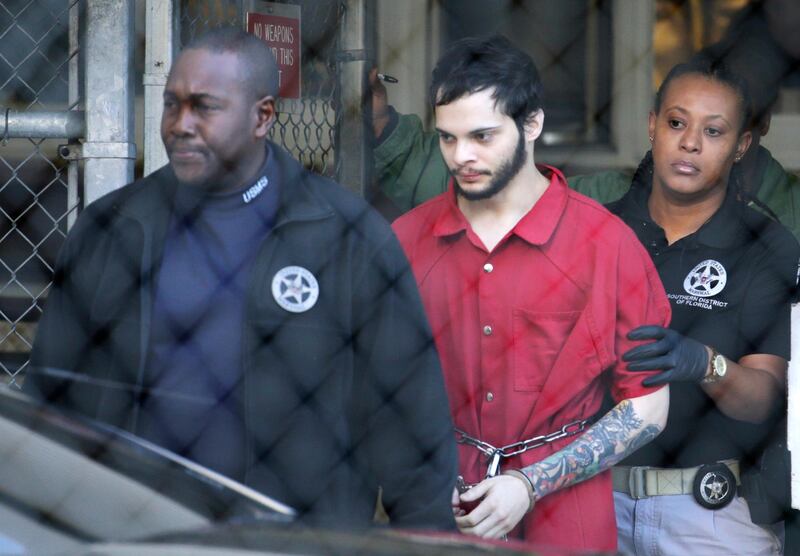 FILE - In this Jan. 30, 2017, file photo, Esteban Santiago, center, is led from the Broward County jail for an arraignment in federal court in Fort Lauderdale, Fla. Federal prosecutors on Monday, May 21, 2018, filed court documents in which agrees to plead guilty to a Florida airport shooting rampage that killed five people and wounded six last year. The agreement filed Monday says that 28-year-old Santiago will plead guilty to 11 of the 22 counts against him. Prosecutors reached a deal with Santiagoâ€™s defense lawyers not to seek the death penalty in exchange for the guilty plea. Instead, Santiago would serve a life prison sentence.  (AP Photo/Lynne Sladky, File)