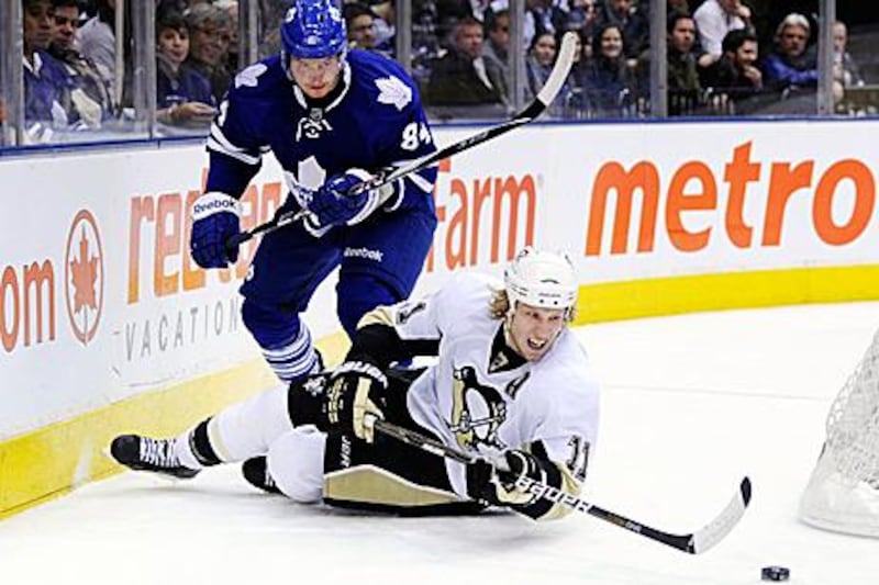 Toronto Maple Leafs's Mikhail Grabovski, who scored the overtime winner, battles for the puck with  Pittsburgh Penguins's Jordan Staal.
