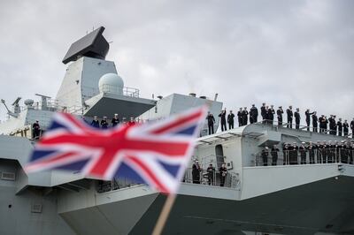 People cheer as 'HMS Queen Elizabeth' arrives in Portsmouth, England. Getty Images