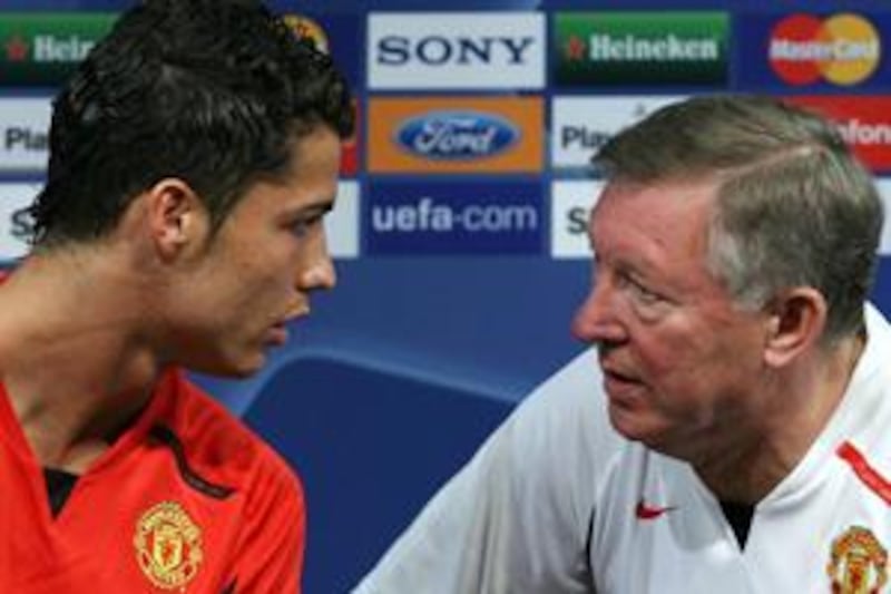 Alex Ferguson, right, says that Manchester United could not have kept Cristiano Ronaldo any longer after selling him to Real Madrid in 2009. AFP