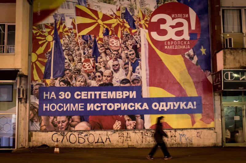 SKOPJE, MACEDONIA - SEPTEMBER 29: People walk past a referendum poster saying 'Yes for European Macedonia' on September 29, 2018 in Skopje, Macedonia. Macedonians will go to the polls Sunday to vote in a referendum to change the countries name to the "Republic of North Macedonia" and end a long running dispute with Greece. The result could allow the country to qualify for NATO membership and help push towards membership to the European Union.  (Photo by Chris McGrath/Getty Images)