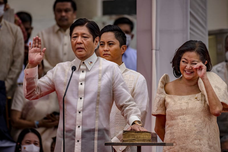 Mr Marcos Jr, with his wife Louise Araneta-Marcos and son Ferdinand Alexander Marcos, takes the oath as the next Philippine president in Manila. Getty