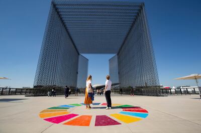 Visitors stand inside SDG wheel at the Sustainability Portal at Expo 2020 Dubai.