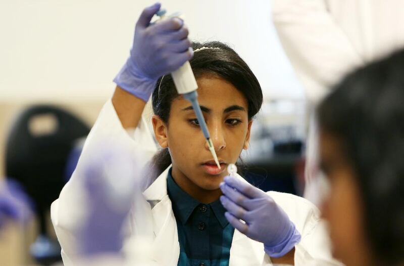 Maryam Al Hashimi from Al Yasmina School in Abu Dhabi learns how to test food for bacterial contamination during the Genes in Space workshop in the lab of Emirates College for Advanced Education in Abu Dhabi. Pawan Singh / The National