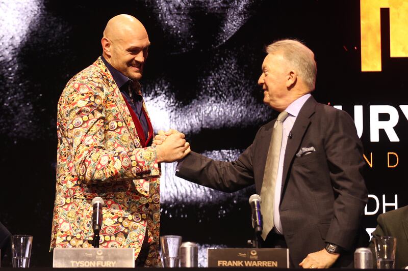Tyson Fury, left, shakes hands with boxing promoter Frank Warren. Getty 
