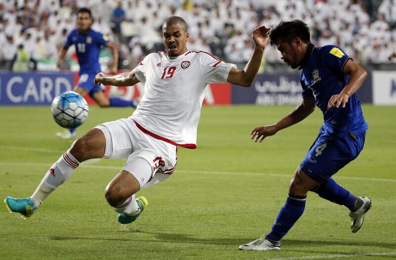 UAE’s Ismail Ahmed, left, attempts to block a cross by Thailand’s Teerasil Dangda. Karim Sahib / AFP