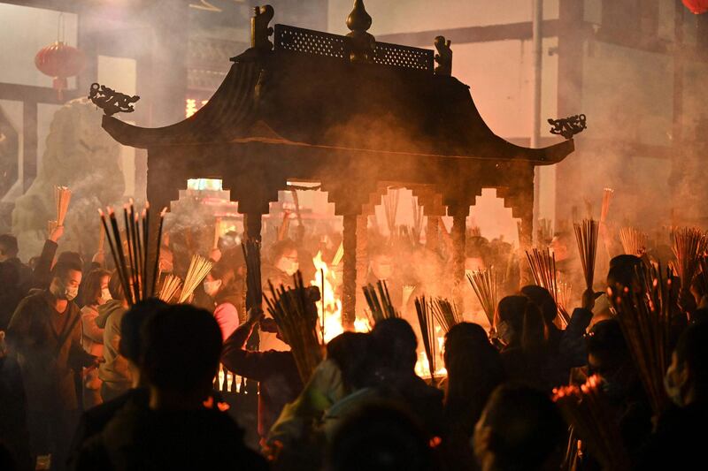 People burn incense and pray for good luck on the eve of the Lunar New Year at a temple in Nanning, in China's southern Guangxi region. AFP