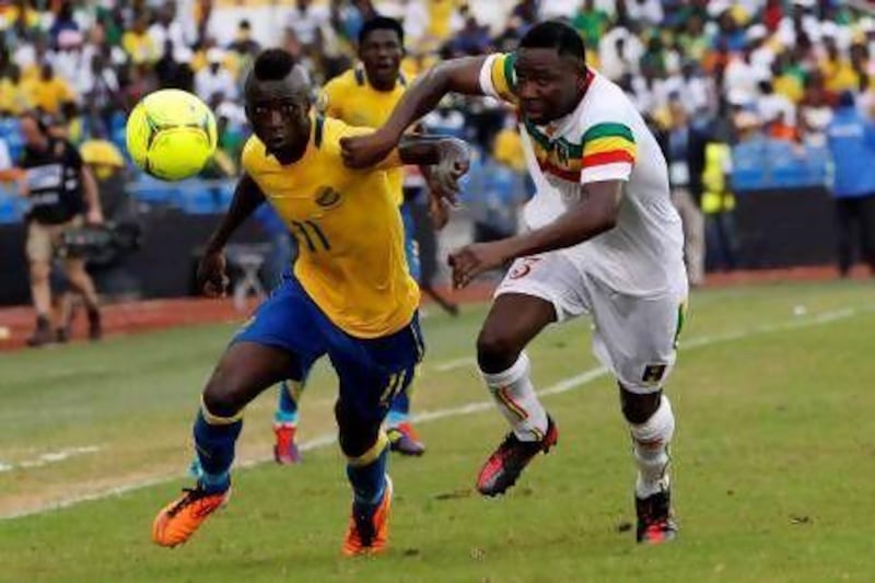 Eric Mouloungui, left, has played for Gabon with seven goals in 31 appearances.