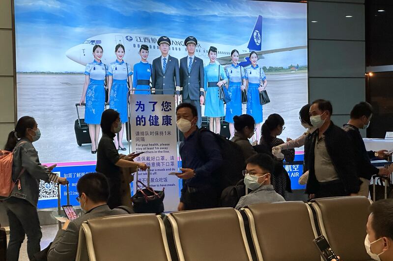 Passengers prepare to board a flight at an airport in China's Jiangxi province. AP