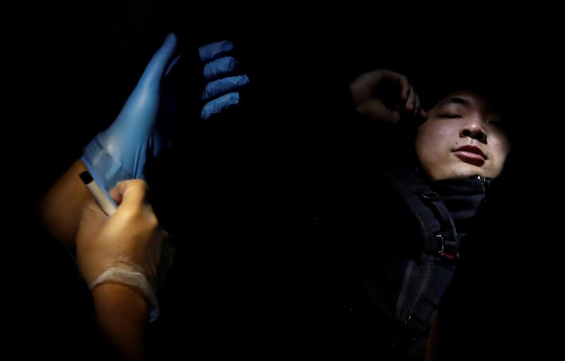 A protester receives medical attention during a standoff with riot police at the Chinese University of Hong Kong. Reuters