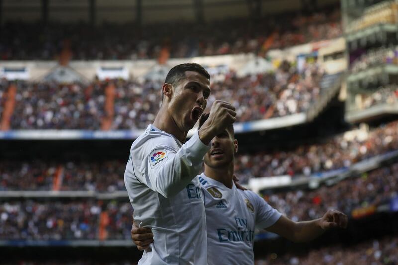 MADRID, SPAIN - DECEMBER 09: Cristiano Ronaldo (L) of Real Madrid CF celebrates scoring their second goal with teammate Marco Asensio (R) during the La Liga match between Real Madrid CF and Sevilla FC at Estadio Santiago Bernabeu on December 9, 2017 in Madrid, Spain . (Photo by Gonzalo Arroyo Moreno/Getty Images)