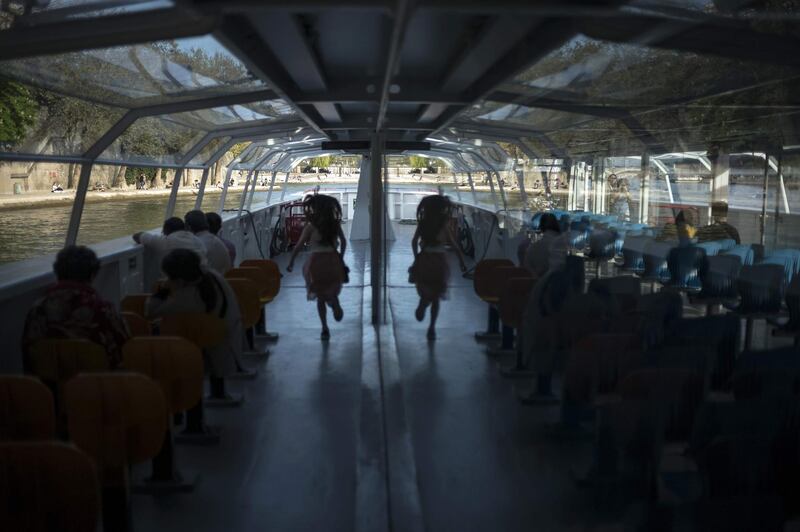 Tourists enjoy a river boat ride on the Seine in Paris. Lionel Bonaventure / AFP Photo