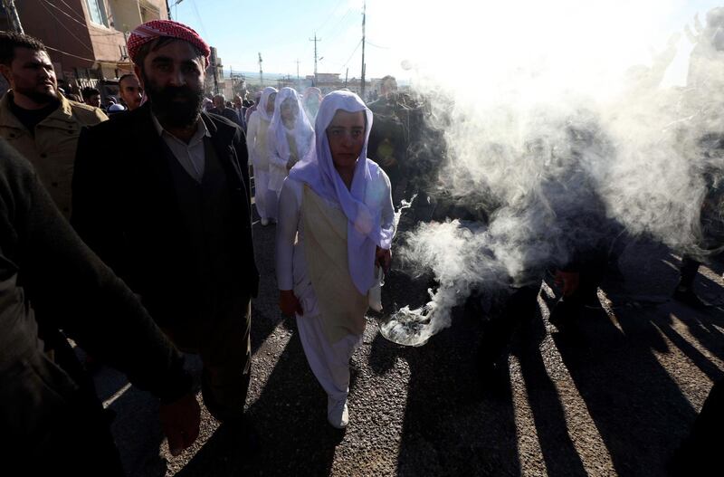 Iraqi Yazidis attend the funeral of the Prince Tahseen Said Ali, the leader of the world's Yazidis, in the town of Sheikhan, 50km northeast of Mosul. AFP