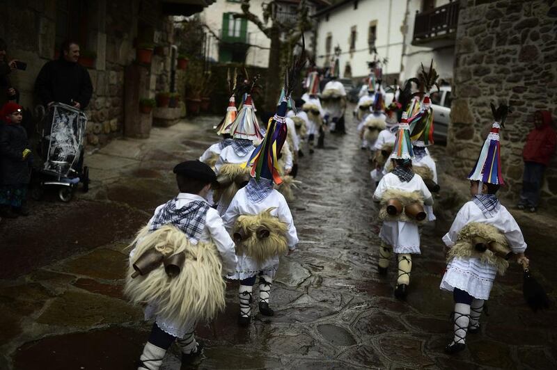 Young Joaldunak perform a ritual dance during carnival celebrations in Zubieta, Spain, on January 28, 2014. The bell-carrying dancers from Zubieta and the neighbouring town of Ituren visit each other’s villages to ward off evil spirits and awaken the coming spring. Alongside the dancers, villagers dress in bizarre and frightening costumes to harass and scare visitors. Vincent West / Reuters