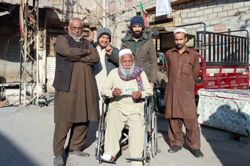 A disabled man being taken to cast his vote in Peshawar, Pakistan. Musa Kamal for The National