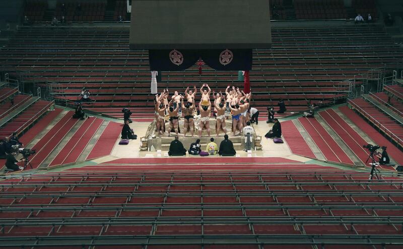 No spectators are present to see Sumo wrestlers hold a Dohyo ring entering ceremony at the Spring Grand Sumo Tournament in Osaka, Japan, on Sunday March 8. Reuters