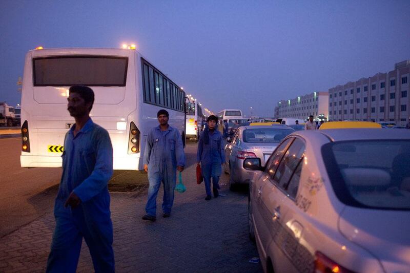 Abu Dhabi, United Arab Emirates, July 25, 2013:     Labourers wait for buses to take them to work after morning prayers outside the Workers Village Labour Camp during the holy month of Ramadan in the Musaffah area of Abu Dhabi on July 25, 2013. Christopher Pike / The National

Reporter: none